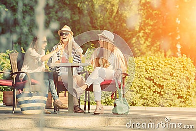 Girlfriends enjoying cocktails in an outdoor cafe, friendship concept Stock Photo