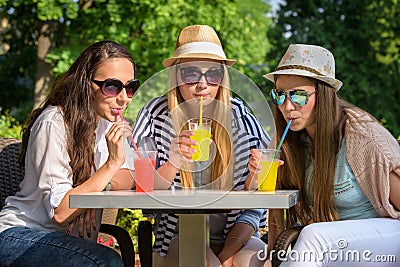 girlfriends enjoying cocktails in an outdoor cafe, friendship concept Stock Photo