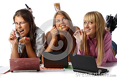 Girlfriends lay with laptops and sugar candies Stock Photo