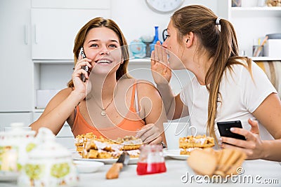 Girlfriends are playfull talking by phone Stock Photo