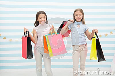 Girlish happiness. Kids happy carry bunch packages. Shopping with best friend concept. Girls like shopping. Kids happy Stock Photo