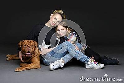 Girls with big brown dog Stock Photo