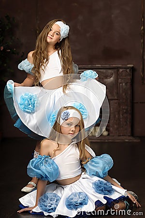 Girls in blue with white tops and skirts Stock Photo