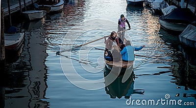 Girls on boat on Venetian canal Stock Photo