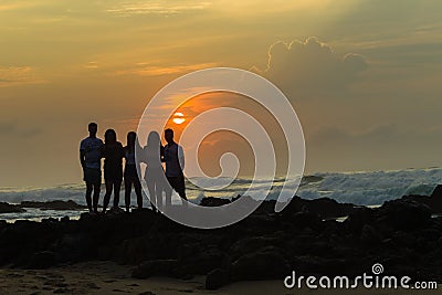 Girls Boys Silhouetted Beach Sunrise Ocean Stock Photo