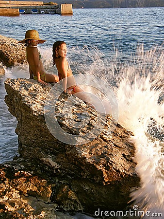 Girls and broken waves Stock Photo