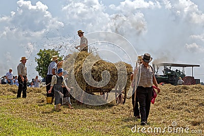 Girls Carry Water for the Hay Crew Editorial Stock Photo