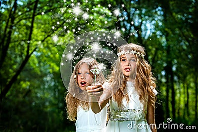 Girls casting magic spells in woods. Stock Photo