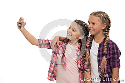 Girls cute small children smiling to phone screen. They like taking selfie for social networks. Problem of young Stock Photo