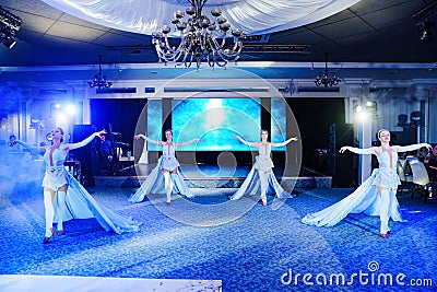 Girls dancers in beautiful stage costumes dancing at a festive banquet. Editorial Stock Photo