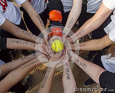 Girls Fastpitch Softball Team Inspirational Huddle Stock Photo