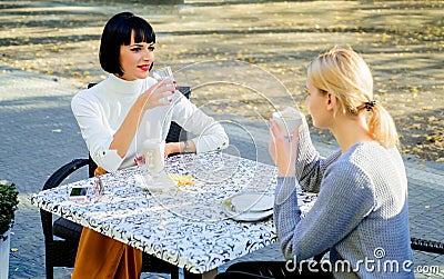 Girls friends drink coffee and talk. True friendship friendly close relations. Conversation of two women cafe terrace Stock Photo