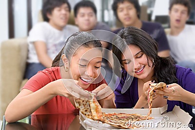 Girls got the first chance to eat pizza Stock Photo