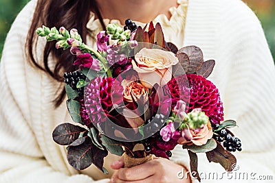 Girls hands holding bouquet flowers in rustic boho style women valentine mother day Stock Photo