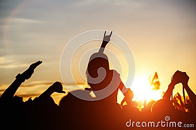 Girls with hands up dancing, singing and listening the music during concert show on summer music festival Stock Photo