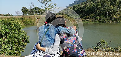 Girls hanging out near a pond at sikuni tea estate area. Editorial Stock Photo