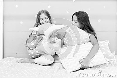 Girls happy friends with cute pillows. Pillow fight pajama party. Sleepover time for pillow fight. Doing whatever they Stock Photo