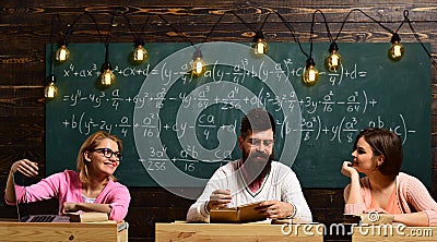 Girls, happy students looking with adoration at bearded teacher, lecturer, professor. College and education concept Stock Photo