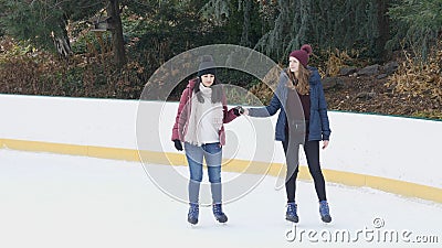 Girls have a lot of fun doing ice skating in New Yorks Central Park Stock Photo