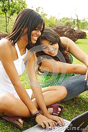 Girls having fun with notebook Stock Photo