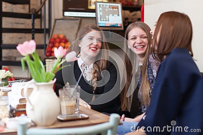 Girls having a small talk in coffee shop Stock Photo