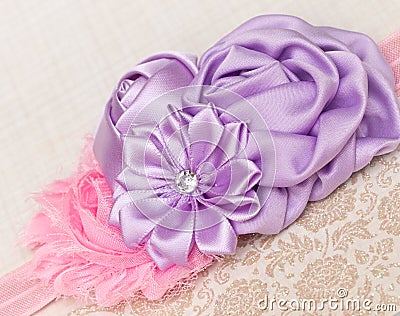 Girls Headband. Pink shabby flower with rosettes and a diamonte. Stock Photo