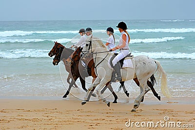 Girls and horses on beach ride Editorial Stock Photo