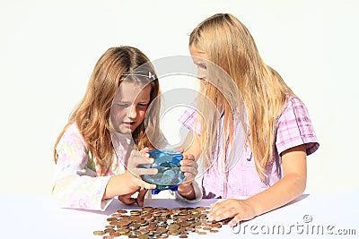 Girls - kids getting out money from saving pig Stock Photo