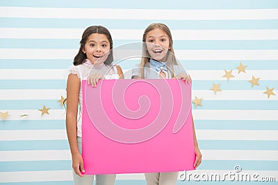 Girls kids hold advertisement poster copy space. Children hold advertising banner. Happy children with blank paper for Stock Photo
