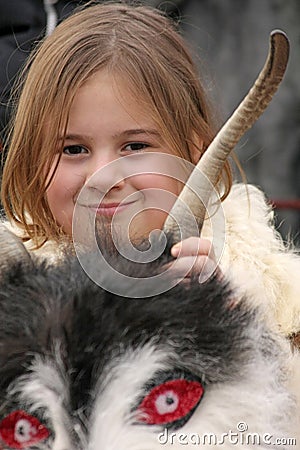 Girls Kukeri, kids mummers perform rituals with costumes and big bells on international festival of masquerade games â€Survaâ€ Editorial Stock Photo