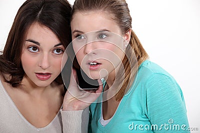 Girls listening to a cellphone Stock Photo