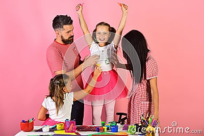 Girls, man and woman with cheerful and concentrated faces Stock Photo