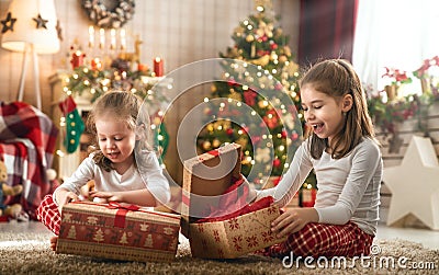Girls opening Christmas gifts Stock Photo