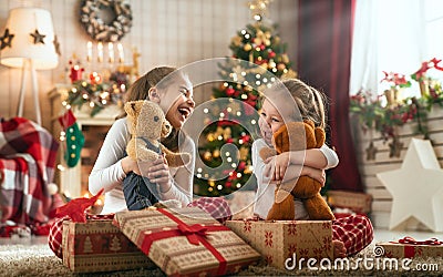 Girls opening Christmas gifts Stock Photo