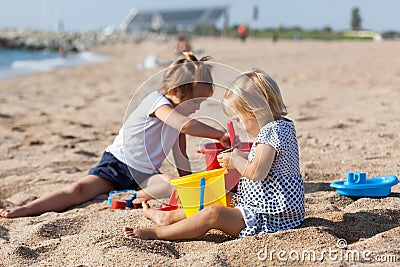 Girls play on the beach Stock Photo