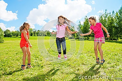 Girls play jumping over the rope Stock Photo