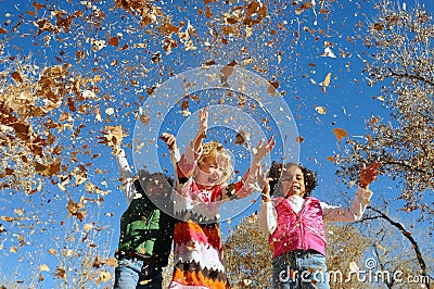 Girls playing with leaves Stock Photo