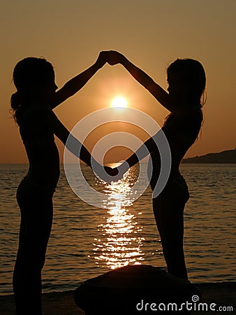 Girls playing in sunset Stock Photo