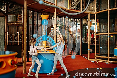 Girls plays air gun machine, children game center Stock Photo