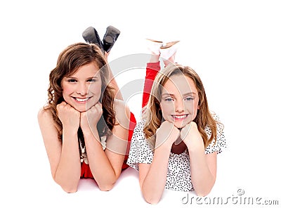 Girls posing with hands on chin. Lying on floor Stock Photo