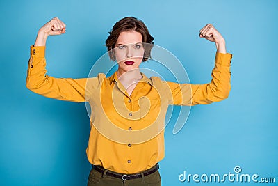 Girls power. Photo of pretty serious lady hold raise biceps two hands showing perfect biceps after gym training wear Stock Photo