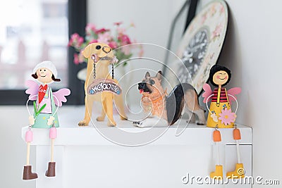 Girls and puppy dolls on a white table, home decorative. Stock Photo