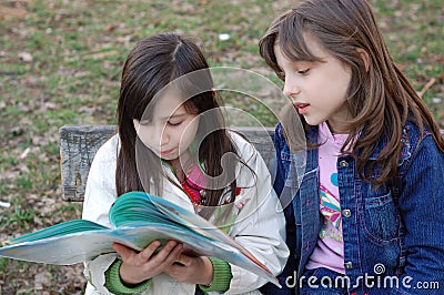 Girls reading book Stock Photo