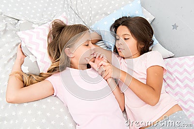 Girls relaxing on bed. Slumber party concept. Girls just want to have fun. Invite friend for sleepover. Best friends Stock Photo