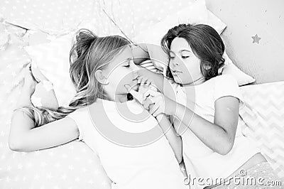 Girls relaxing on bed. Slumber party concept. Girls just want to have fun. Invite friend for sleepover. Best friends Stock Photo