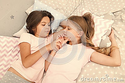 Girls relaxing on bed. Slumber party concept. Girls just want to have fun. Invite friend for sleepover. Best friends Stock Photo