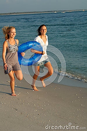 Girls running with float Stock Photo