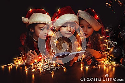 Girls in Santa hats have a Christmas Stock Photo