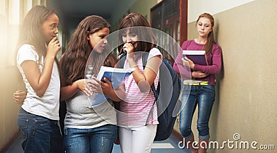 Girls, school and bullying student in gossip, secret or whisper down the corridor or hallway. Group of young kids or Stock Photo