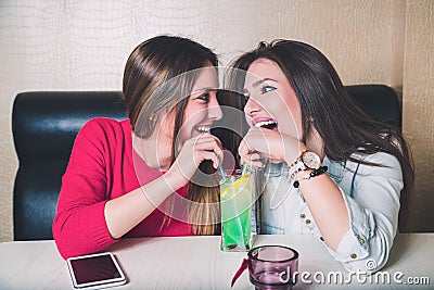 Girls share fruit cocktail Stock Photo
